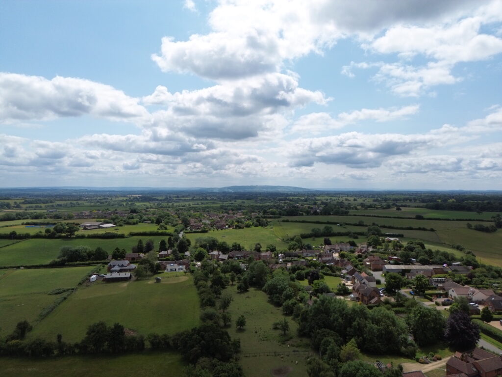 A landscape image of a large rural area of farm fields and modest houses in Worcestershire.